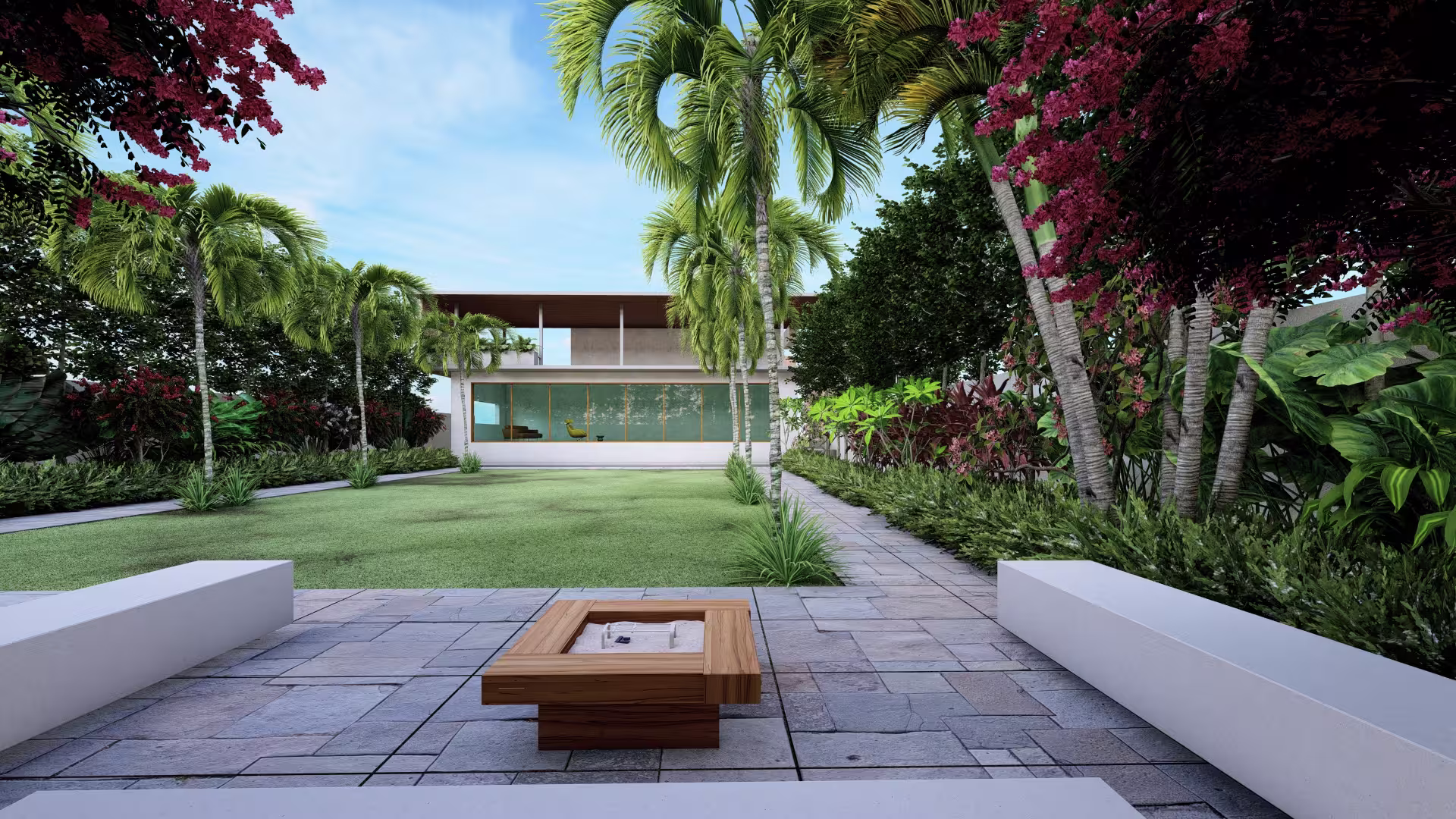 Modern house with large glass windows, surrounded by palm trees and lush gardens, viewed from a tiled patio with a square wooden fire pit and white benches.